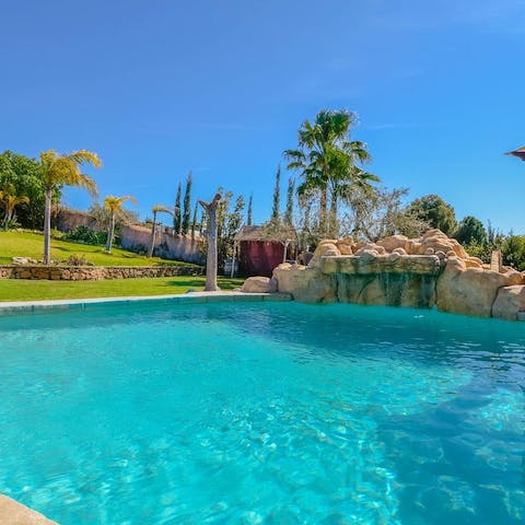 Float blissfully in your pristine pool to the sounds of the waterfall