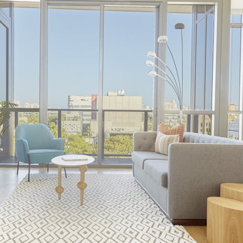 Enjoy gorgeous views of the city from the comfort of the sofa or out on the balcony