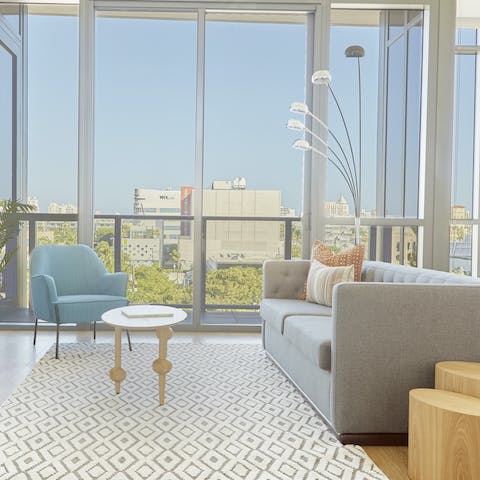 Enjoy gorgeous views of the city from the comfort of the sofa or out on the balcony