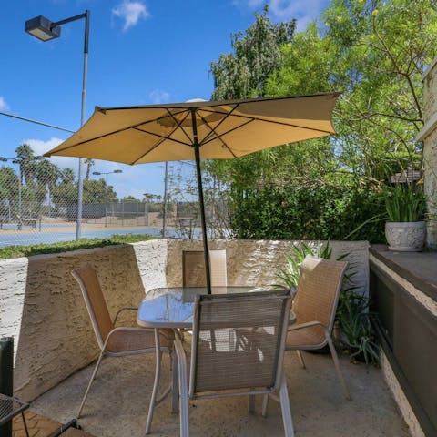 Sit down to an alfresco meal beneath the sun umbrella