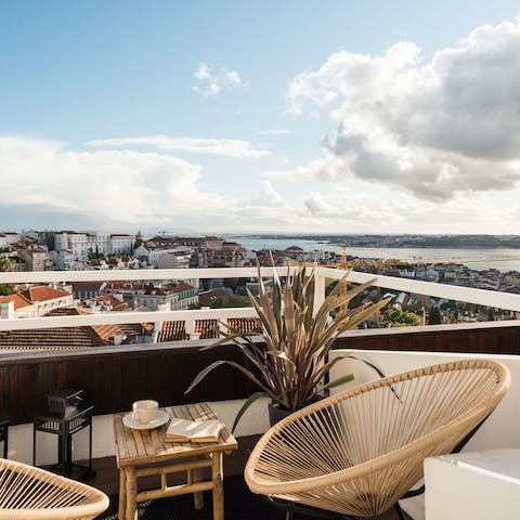 Enjoy a cocktail on the private balcony as the sun sets over the city's rooftops