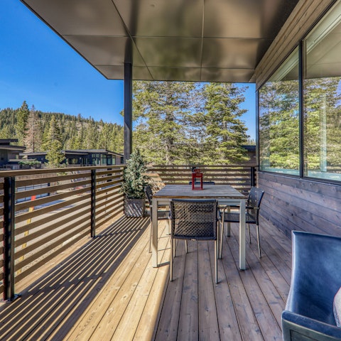 Take in the views of the towering pines from the balcony