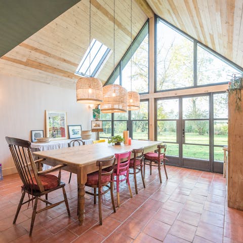 Admire the view of the garden from the floor-to-ceiling window in the dining room