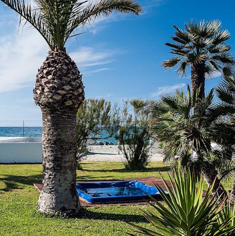 Unwind with a soak in the private jacuzzi as the palms sway above you