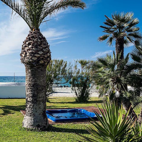 Unwind with a soak in the private jacuzzi as the palms sway above you