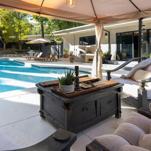 Enjoy drinks by the pool as the sun sets