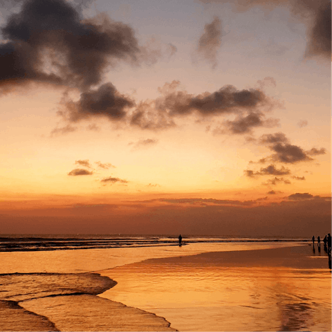 Stroll along the sands of Seminyak Beach at the golden hour, just a short walk away