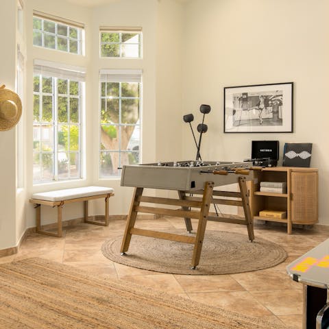 Listen to a record while playing a game of table football in the living area
