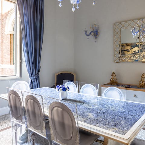 Serve up a delcious Italian meal in the dining room, filled with striking, deep blue marble and a Murano glass chandelier