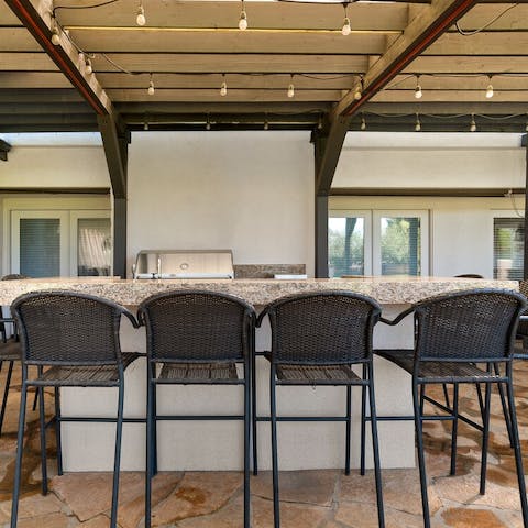 Gather around the bar to sip cocktails in the sun