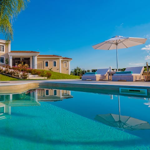 Pick a shaded spot by the huge swimming pool