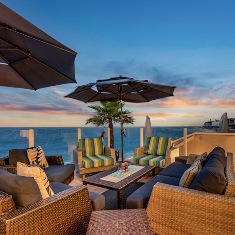 Gather on the terrace for cocktails as the goes down
