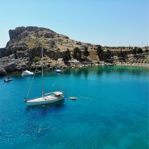 Take a dip in the sparkling blue waters of the Aegean Sea, just a twenty-minute walk away