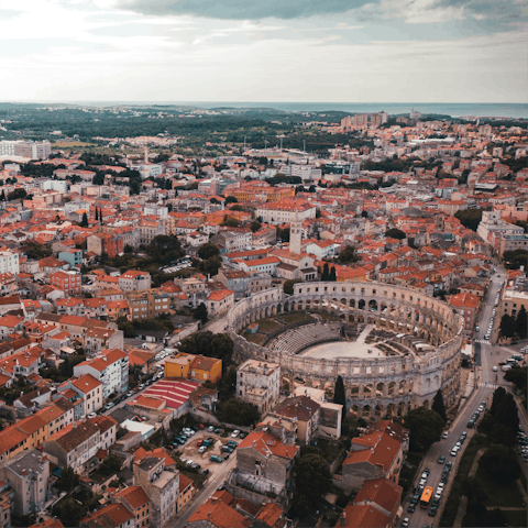 Explore the Roman ruins in the nearby city of Pula