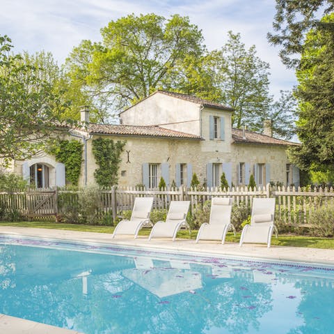 Spend mornings lounging by the pool on sun loungers