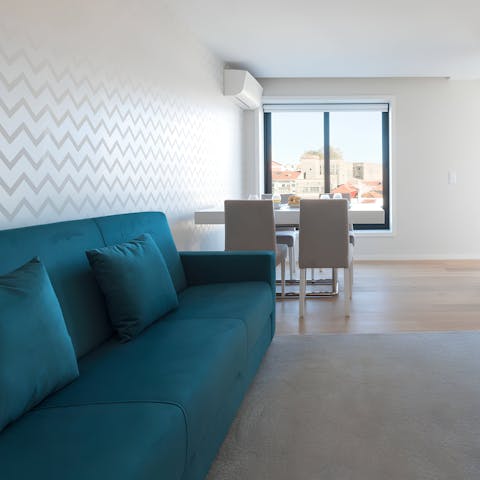 Enjoy a meal at the window-side table, feasting on rooftop views