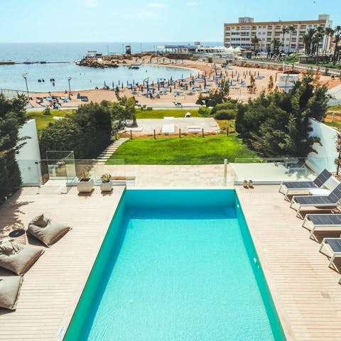 Relax by the pool with a front-row view of the beach