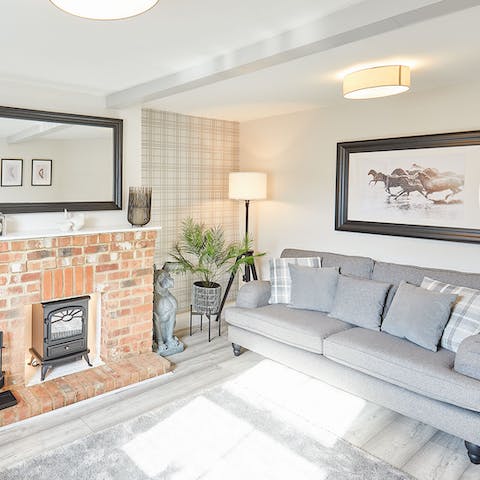 Get cosy on the plush sofa with the warmth of the wood burner