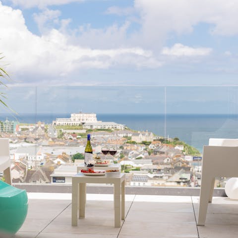 Admire the views over the Cornish coast with a glass of your favourite tipple