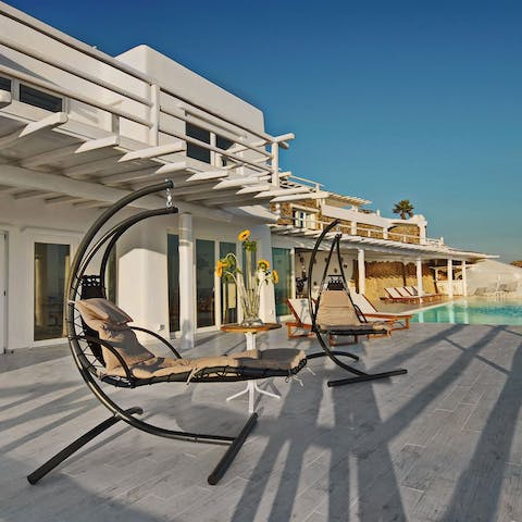 Unwind to an ocean view on suspended sun loungers