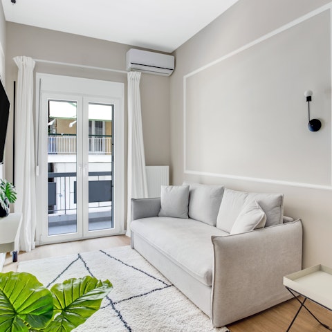 Open up the balcony doors and unwind on the sofas