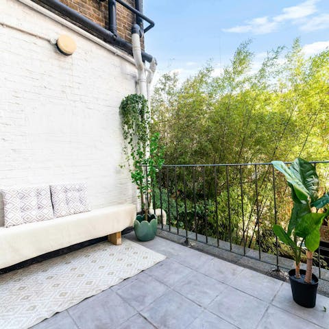 Relax on the cosy balcony overlooking the garden