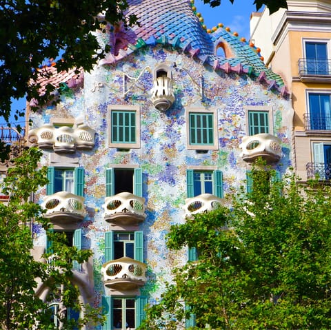 Admire the striking facade of Casa Batlló, a nineteen-minute walk from home