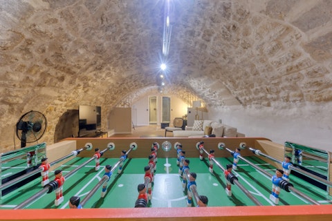 Challenge friends to table football under ancient stone vaults