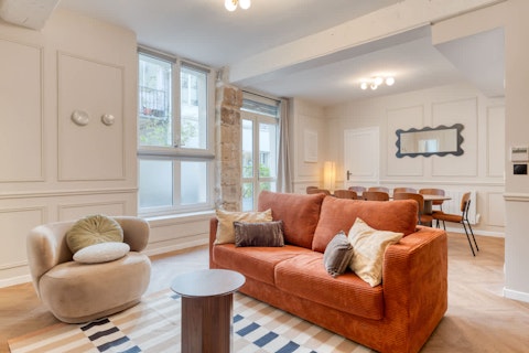 Settle into the light-filled living room where Paris life unfolds outside