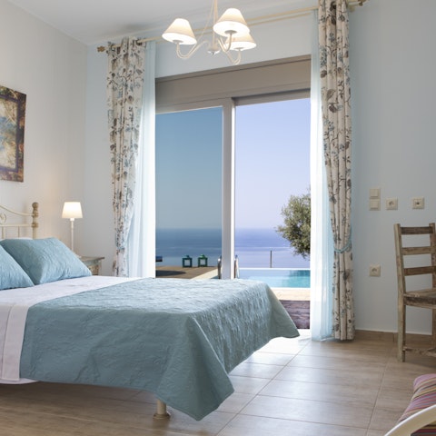 Wake up to beautiful views of the Ionian Sea from the bedroom's glass doors