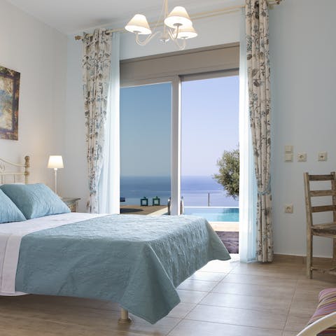 Wake up to beautiful views of the Ionian Sea from the bedroom's glass doors