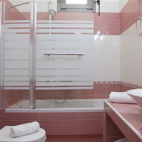 Treat yourself to a rejuvenating session in the fetching pink bathtub