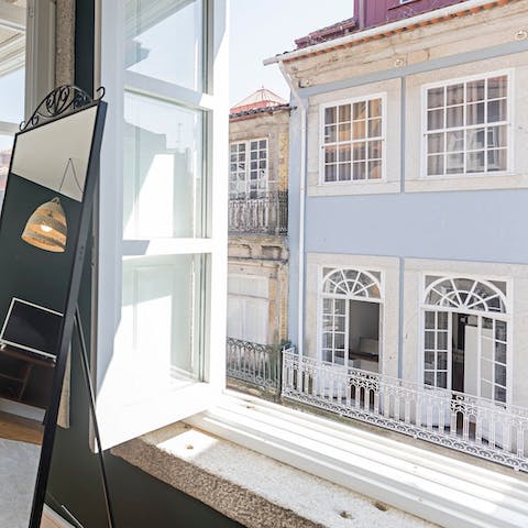 Open up the huge old windows and listen to the street music from below