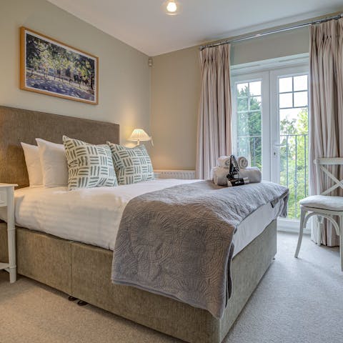 Wake up to green, leafy views through the bedroom's Juliet balcony windows