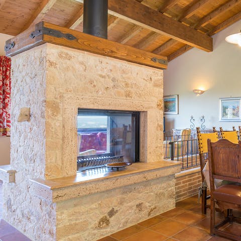 Fire up the double-sided fireplace to keep the dining and living room cosy-warm
