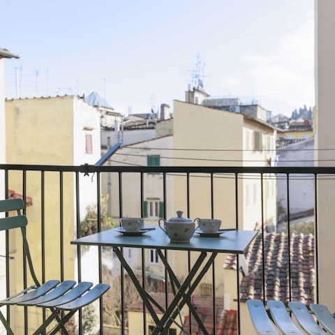 Enjoy breakfast and make plans for the day out on the balcony