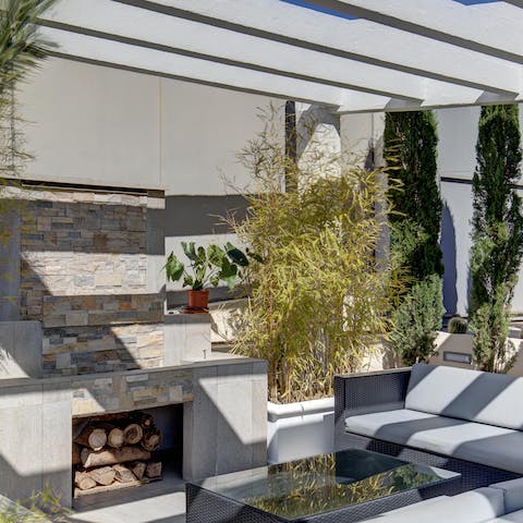 Gather around the outdoor fireplace as the sun goes down