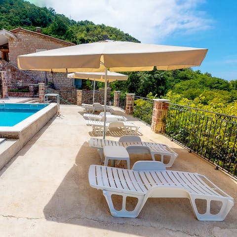 Lie in the shade of the parasols by the pool and start your summertime in style