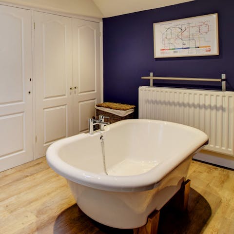 Relax after a long day with a soak in the lush roll-top bathtub