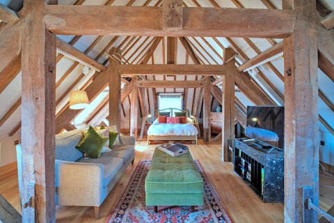 Sleep beneath centuries-old timber beams above a historic town hall