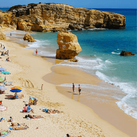 Spend a day on the sands of Praia de São Rafael, a short walk away