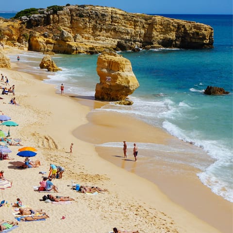 Spend a day on the sands of Praia de São Rafael, a short walk away