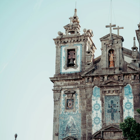 Marvel at the blue-tiled Church of Saint Ildefonso, five minutes away