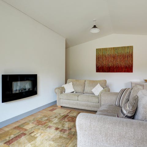 Snuggle up by the living room's electric fire with a good book