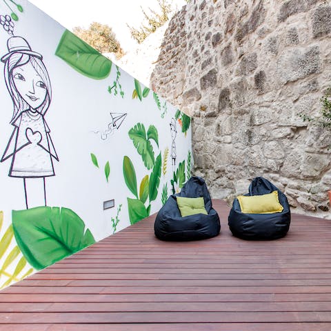 Head out onto the apartment's terrace and relax next to the unique mural
