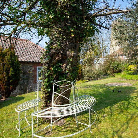 Tuck into a good book under the shade of the garden's apple tree