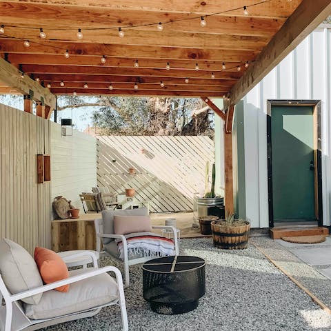 Spend evenings sipping drinks around the fire pit on the front patio