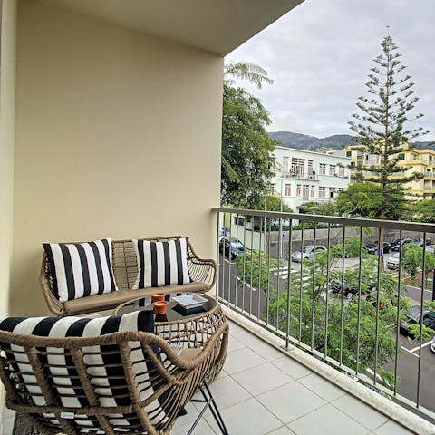 Pour yourself a glass of poncha and watch the sun go down on the private balcony