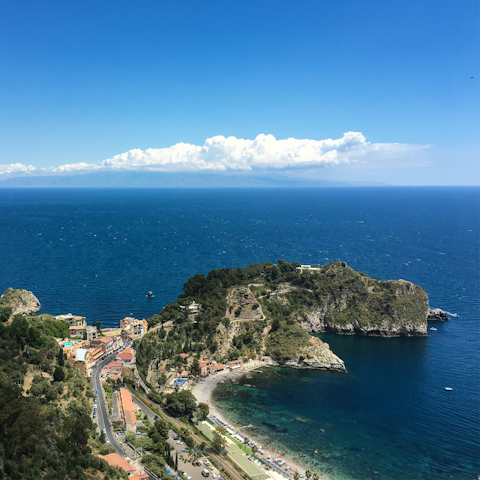 Take a scenic drive through the hills to reach picturesque Taormina, less than an hour away