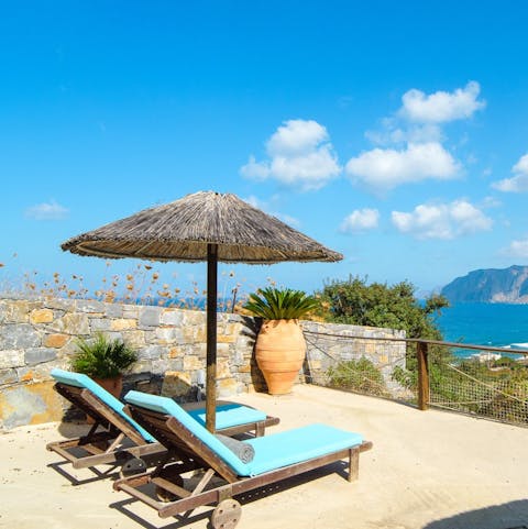 Relax on a sun lounger overlooking the perfectly blue seas of the Mirabello Bay